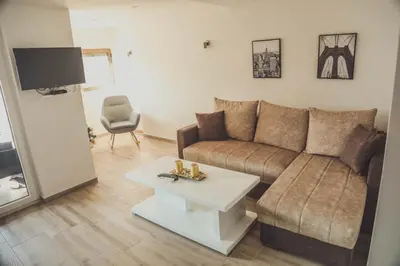 a living room with a couch and a table at Luna-L in Vrnjačka Banja