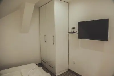 a white cabinet with a flat screen tv on it at Luna-L in Vrnjačka Banja