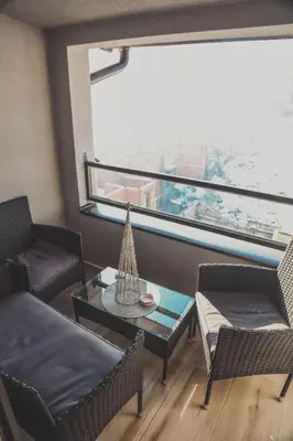 a living room with a couch and chairs and a table at Luna-L in Vrnjačka Banja