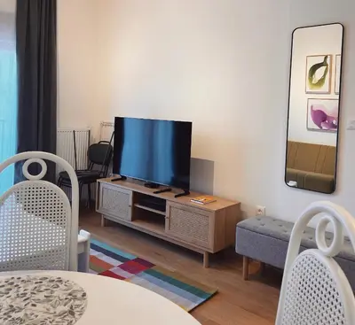 a living room with a flat screen tv on a cabinet at Apartman A4 in Vrnjačka Banja