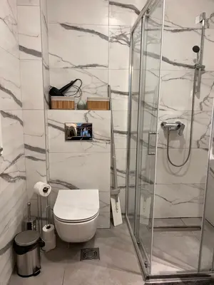 a bathroom with a toilet and a glass shower at Apartman A4 in Vrnjačka Banja
