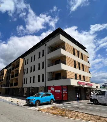 a blue car parked in front of a building at Apartman A4 in Vrnjačka Banja