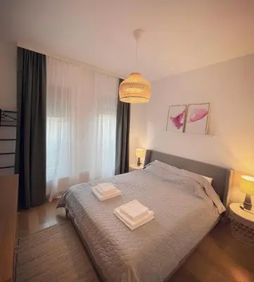 a bedroom with a bed with two towels on it at Apartman A4 in Vrnjačka Banja