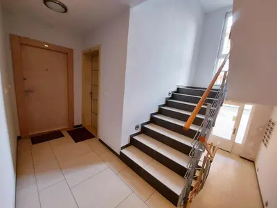 a staircase in a room with a door at Apartman Maslačak Vrnjačka Banja in Vrnjačka Banja