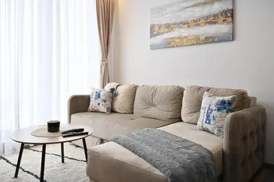 a living room with a couch and a table at Zeleni vrh A03 in Kopaonik