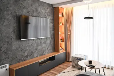 a living room with a television on a wall at Zeleni vrh A03 in Kopaonik
