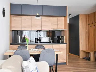 a kitchen and dining room with a table and chairs at Zeleni vrh A03 in Kopaonik