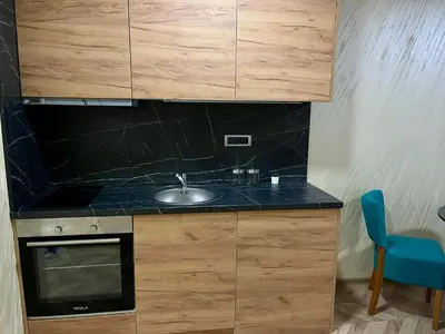 a kitchen with a sink and a counter top at Pink Apartmani in Jagodina