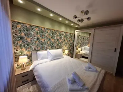 a bedroom with a large bed and a large mirror at Astera 1 in Vrnjci
