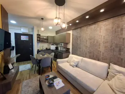 a living room with a white couch and a table at Astera 1 in Vrnjci