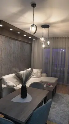 a living room with a table and a couch at Astera 1 in Vrnjci