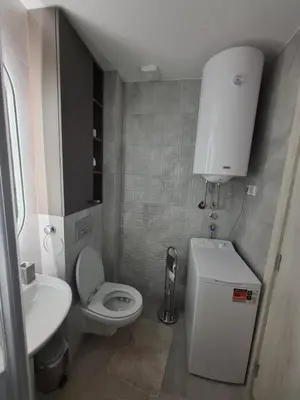 a small bathroom with a toilet and a sink at Astera 1 in Vrnjci