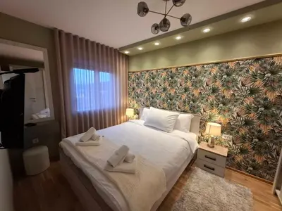 a bedroom with a large bed with towels on it at Astera 1 in Vrnjci