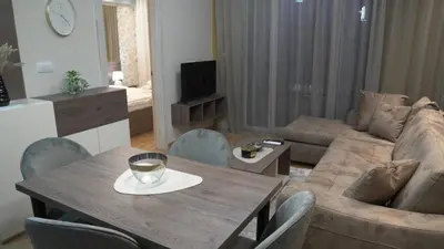 a living room with a table and a couch at Astera 2 in Vrnjci