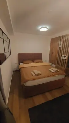 a bedroom with a large bed with two towels on it at Apartman Mećavnik Kopaonik in Kopaonik