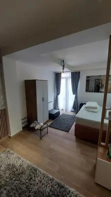 a bedroom with a bed and a large window at Apartman Mećavnik Kopaonik in Kopaonik