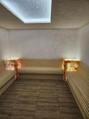 a empty bench in a room with a ceiling at Kopaonik, Apartman FORELIA, Residence hill in Kopaonik