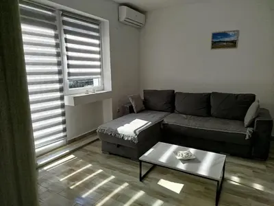 a living room with a couch and a coffee table at Cera residence apartment in Soko Banja