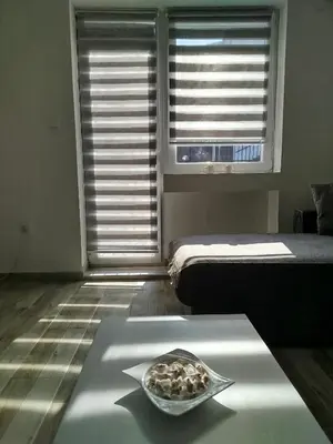 a bowl of food sitting on a table in front of a window at Cera residence apartment in Soko Banja