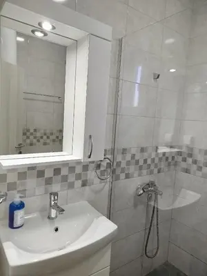 a bathroom with a shower and a sink and a mirror at Cera residence apartment in Soko Banja