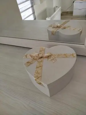 a heart shaped box with a bow on a table at Cera residence apartment in Soko Banja