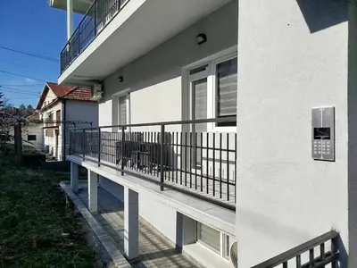 a balcony of a white building with a railing at Cera residence apartment in Soko Banja