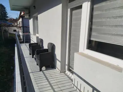 a row of chairs sitting on the side of a building at Cera residence apartment in Soko Banja