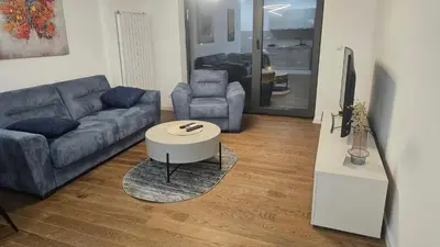 a living room with a couch and a table at Planet A in Niš