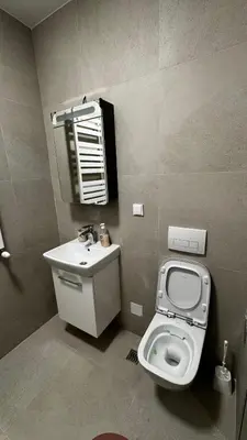 a bathroom with a toilet and a sink and a mirror at Planet A in Niš
