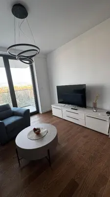 a living room with a couch and a tv at Planet A in Niš