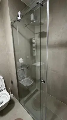 a shower stall in a bathroom with a toilet at Planet A in Niš