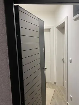 a sliding door in a room with a hallway at Apartmani Ivanović in Vrnjačka Banja