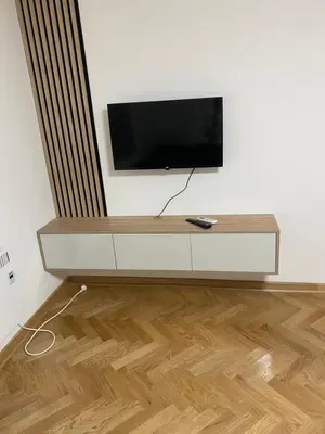 a flat screen tv sitting on top of a white wall at Apartmani Ivanović in Vrnjačka Banja