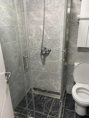 a bathroom with a shower with a toilet at Apartmani Ivanović in Vrnjačka Banja