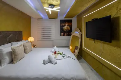 a bedroom with a bed with a teddy bear on it at Matija Lux in Kraljevo