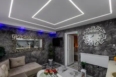 a living room with a large clock on the wall at Matija Lux in Kraljevo