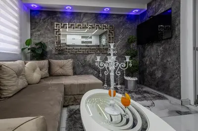 a living room with a couch and a mirror at Matija Lux in Kraljevo