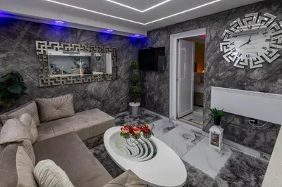 a living room with a large clock on the wall at Matija Lux in Kraljevo