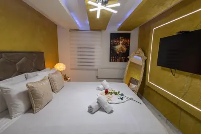 a room with a bed with a television and towels on it at Matija Lux in Kraljevo