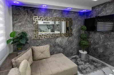 a living room with a couch and a mirror at Matija Lux in Kraljevo