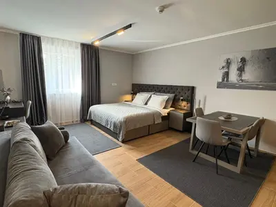 a living room with a bed and a couch at Mountain stars Kopaonik in Kopaonik
