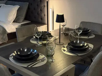 a table with plates and wine glasses on it at Mountain stars Kopaonik in Kopaonik