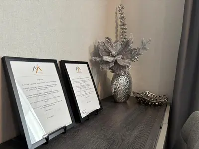 two framed signs on a table with a vase of flowers at Mountain stars Kopaonik in Kopaonik