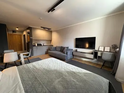 a bedroom with a bed and a living room at Mountain stars Kopaonik in Kopaonik