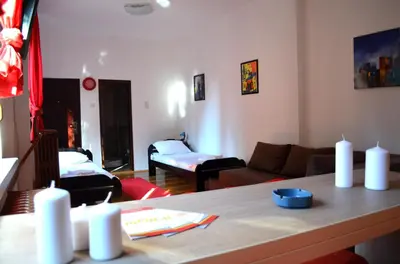 a living room with a couch and a table at Apartmants Night Lux in Niš