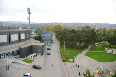 an aerial view of a parking lot in front of a building at Apartmants Night Lux in Niš