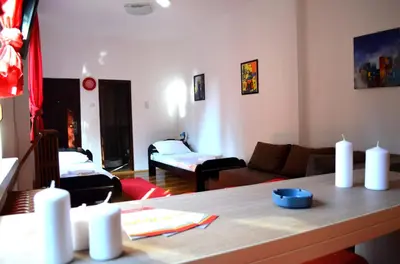 a living room with a couch and a table at Apartmants Night Lux in Niš