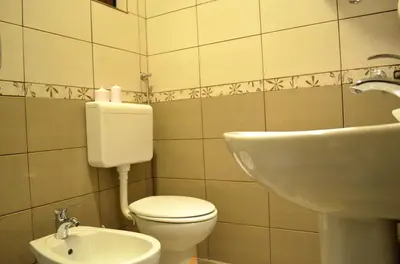 a bathroom with a toilet and a sink at Apartmants Night Lux in Niš
