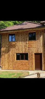 a wooden building with two windows and a door at Ribnjak Filopivic in Pleš