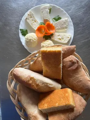 a plate of bread and other foods on a table at Ribnjak Filopivic in Pleš